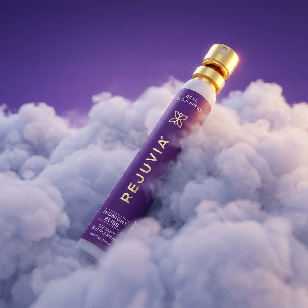 Rejuvia Midnight Bliss oral sleep spray resting on clouds